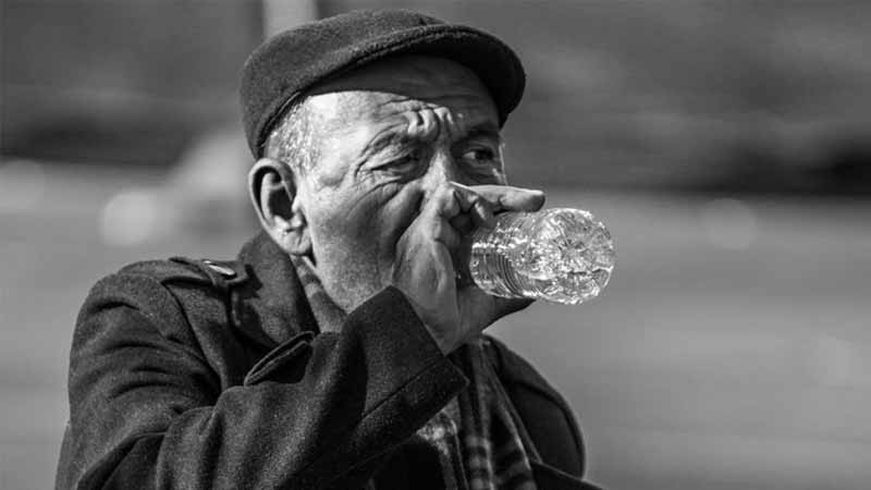 Older man drinking water