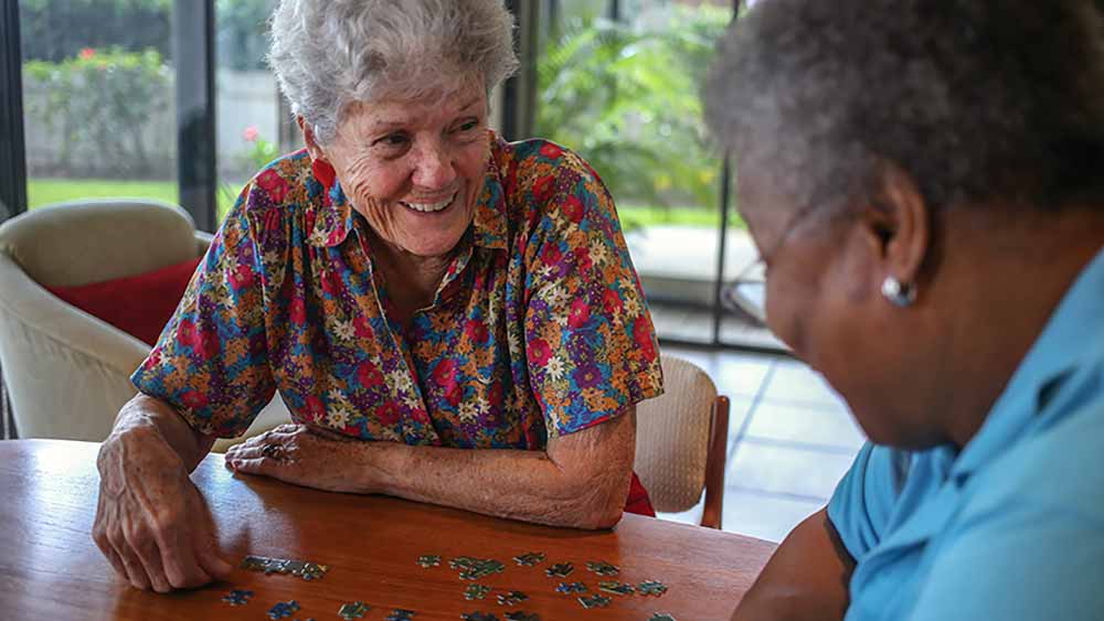 senior ladies putting puzzle together
