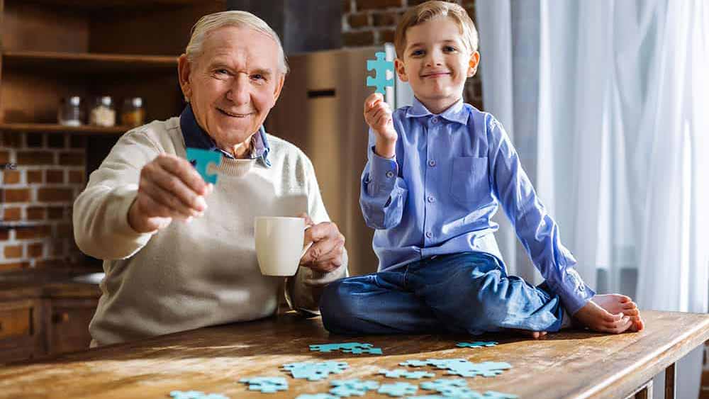 Senior and child playing with puzzle
