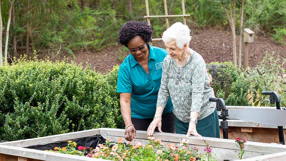 senior-gardening-with-help-of-caregiver
