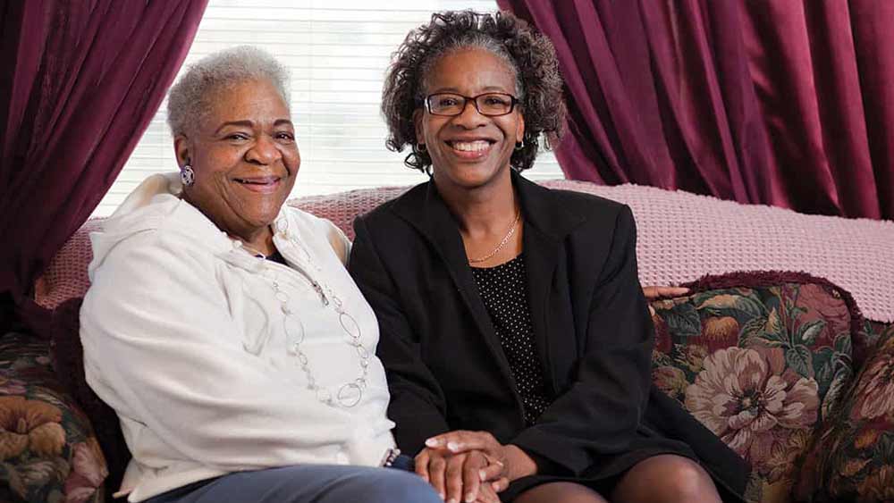 Adult daughter sitting with her elderly mother