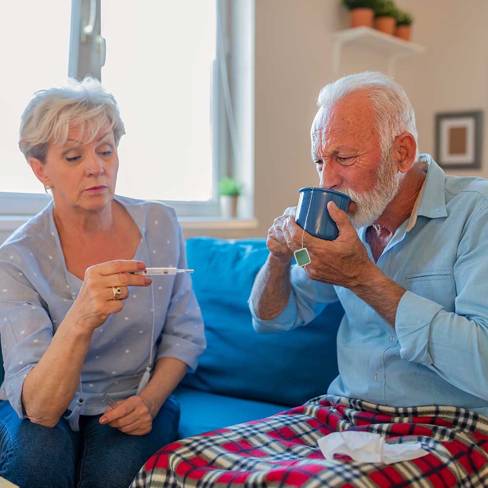 daughter-looking-at-themometer-while-father-drinks