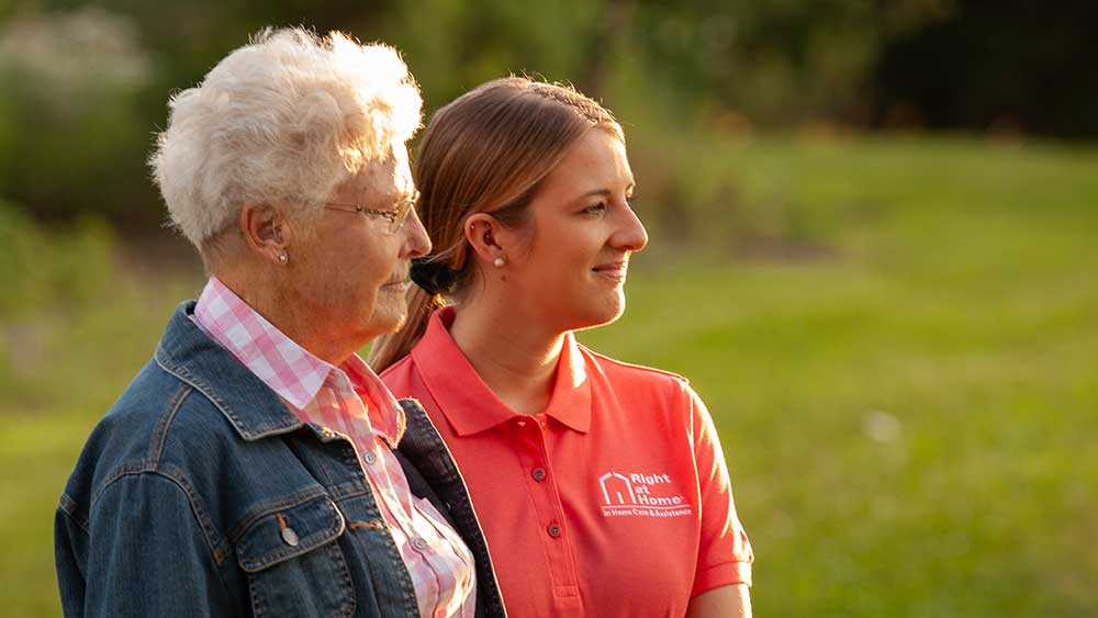 close-up-image-of-senior-woman-and-caregiver-outside