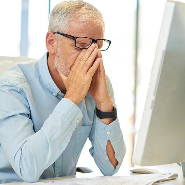 stressed gentleman in front of computer