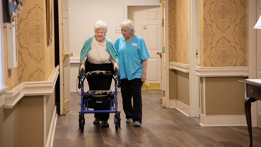 caregiver-assisting-senior-with-walker