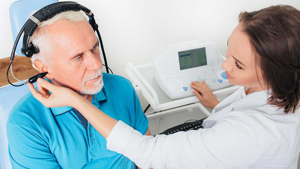 senior-getting-hearing-check