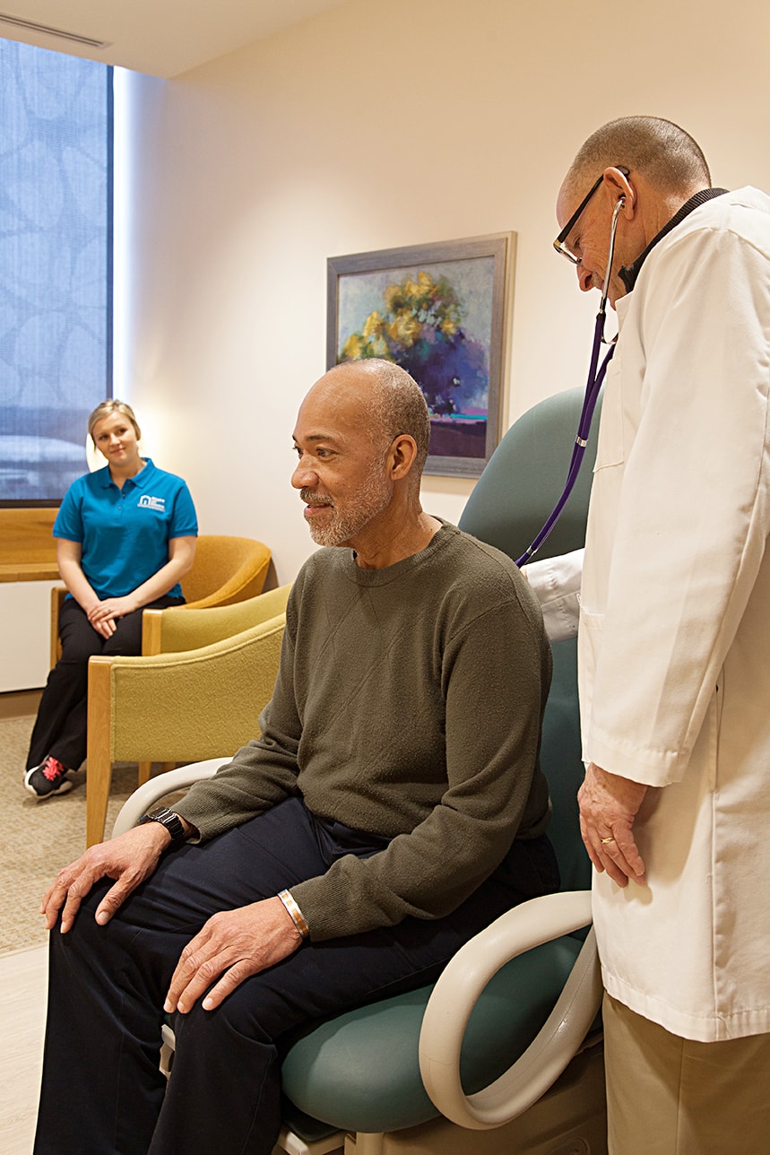 caregiver assisting senior client at doctor appointment