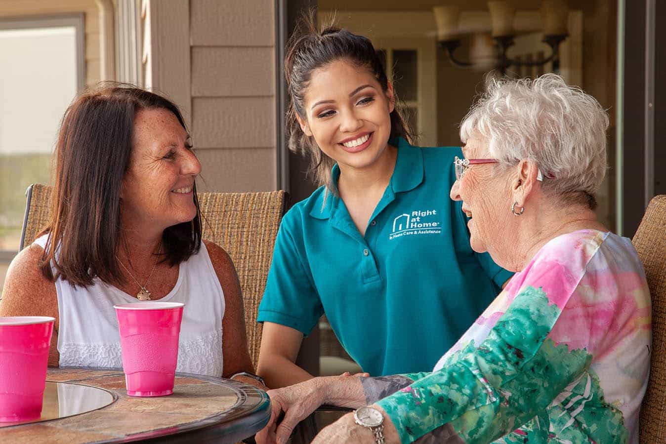 caregiver assisting senior in family conversation