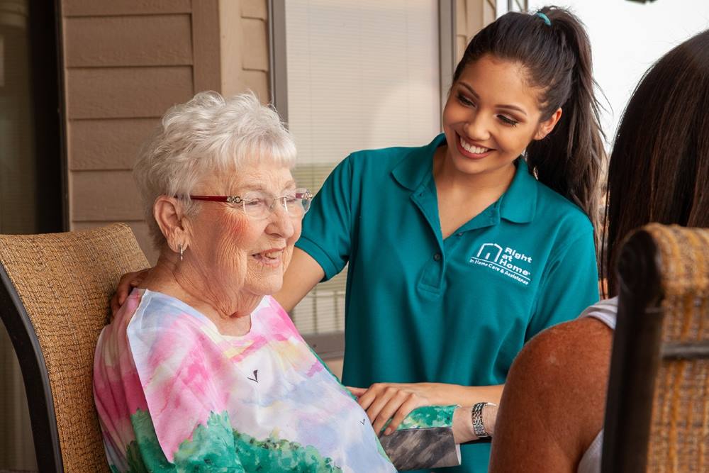 caregiver assisting senior in family conversation