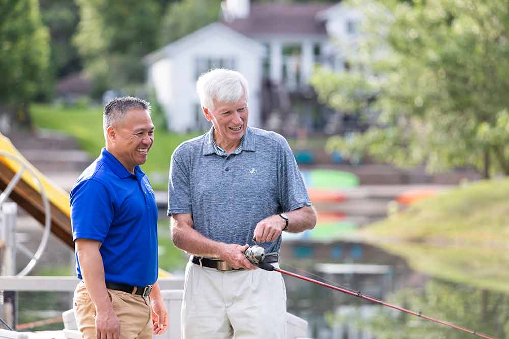 Senior and Caregiver fishing