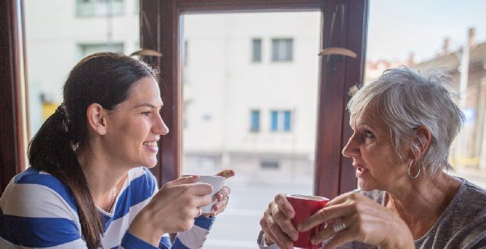 Nursing Student with Elderly Woman Drinking Out of Mugs