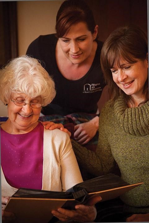 Senior with Family and Right at Home Companion Reading Book