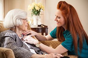 Caregiver helping groom senior