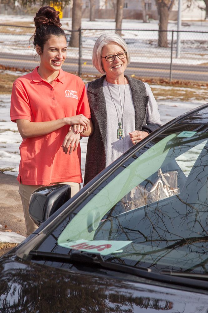 caregiver assists a senior into a lyft vehicle