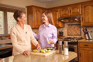 Caregiver helping prepare meal 