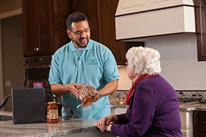 Caregiver helping senior to shop