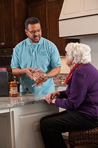 Caregiver helping senior to shop