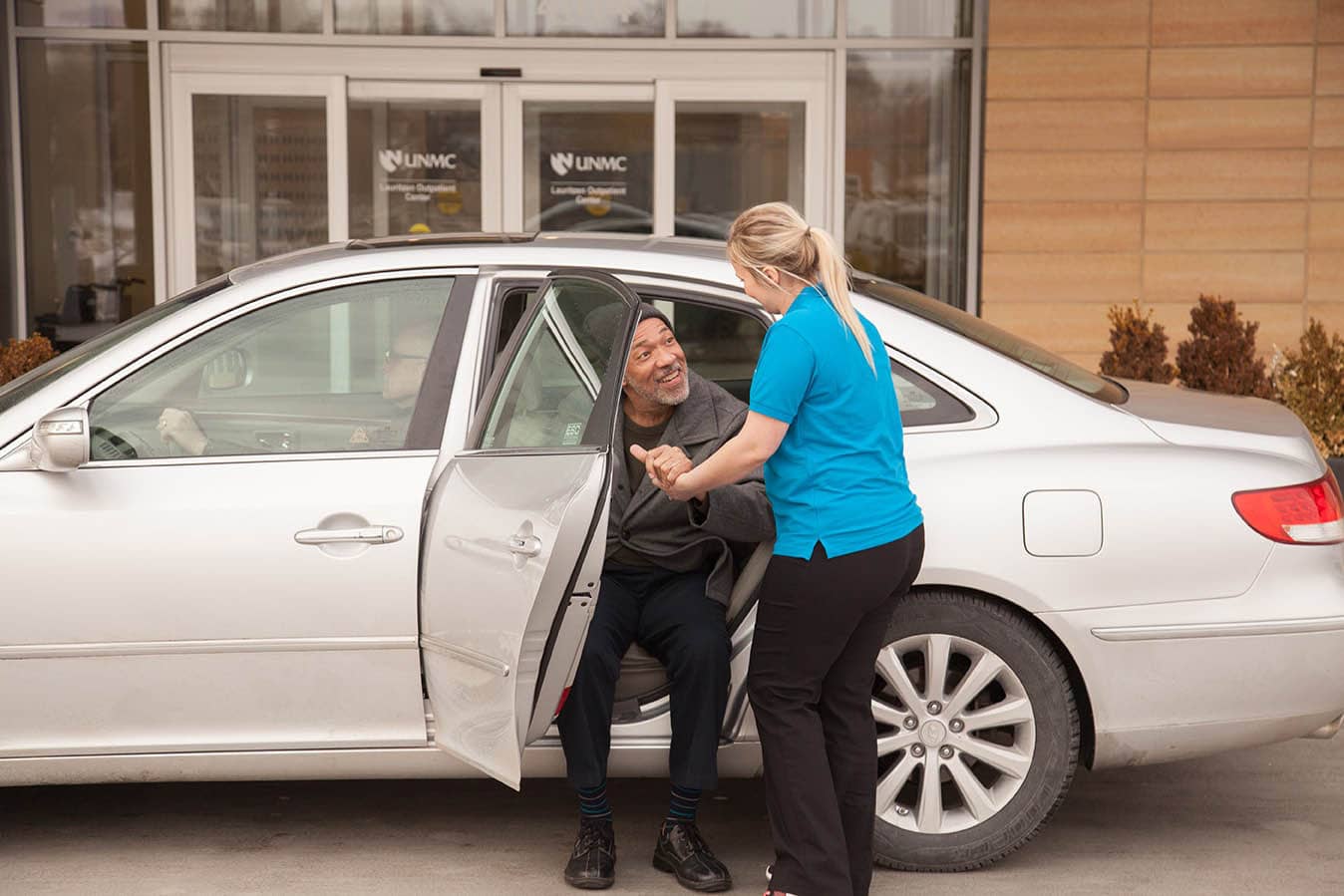 Caregiver helps senior out of car