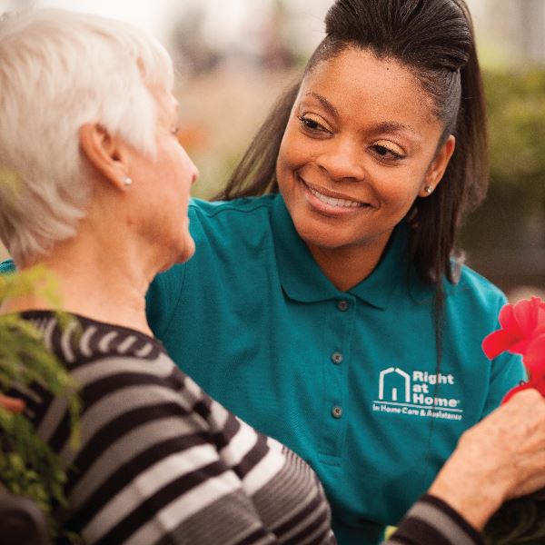 Caregiver with flower for Senior