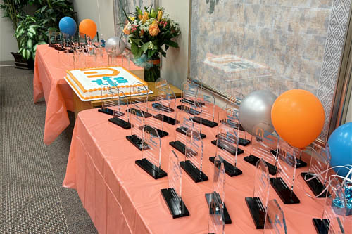 Employee Awards Celebration Tables of Awards Cake and Flowers