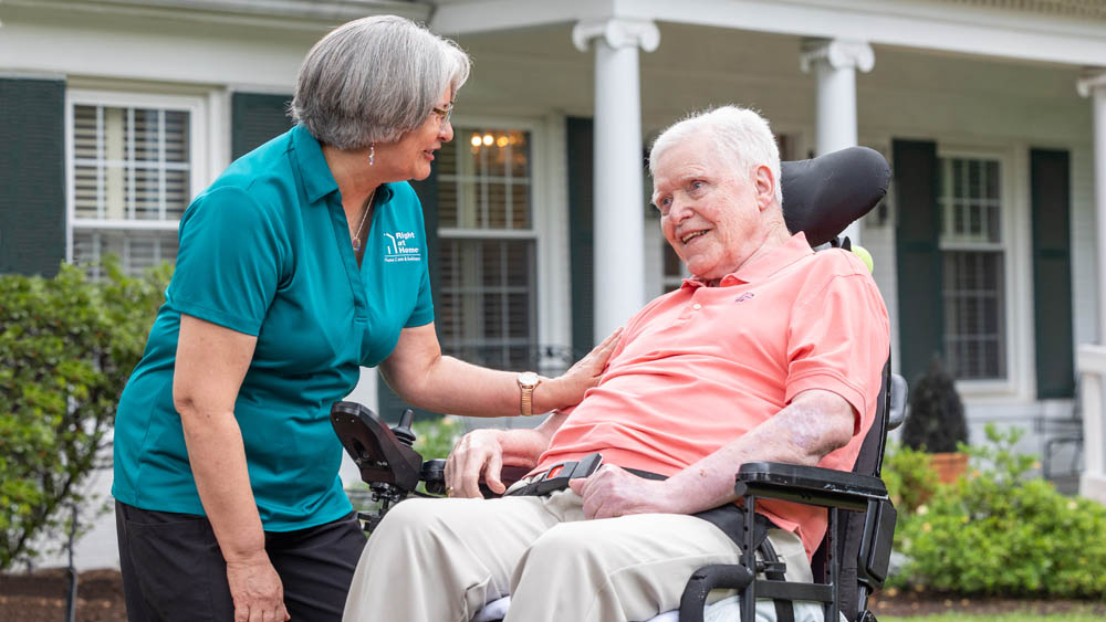 Female Caregiver Caring for a Disabled Adult Male in a Wheelchair