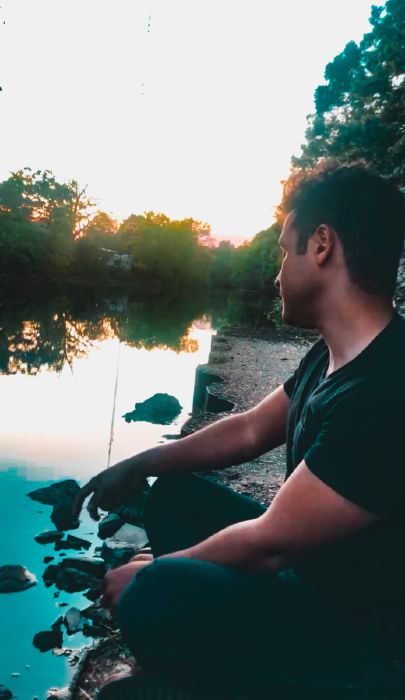 max sitting at the Chestnut Hill Reservoir in Chestnut Hill, MA