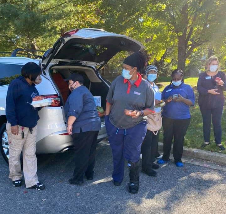 Healthcare workers line up for snacks.