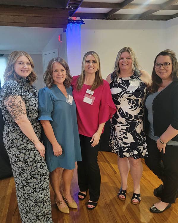 A group of females standing side by side in a room at The Partnership for a Healthier Carroll County event.