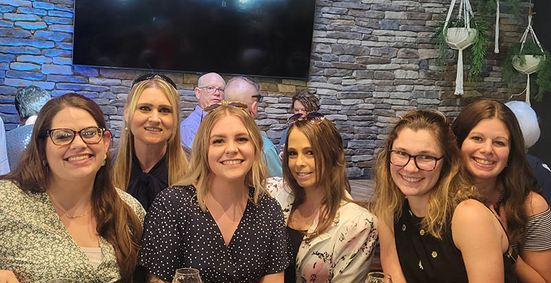 A group of females standing side by side in a room at Taste of Carroll fundraising event.