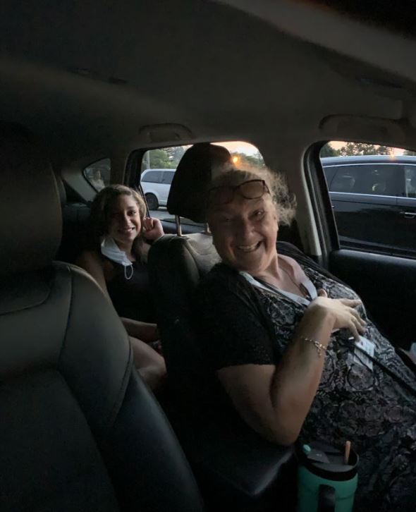 two females in car watching movie at event