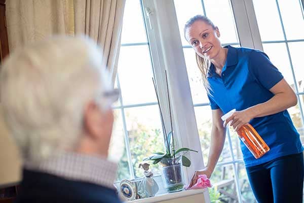 caregiver cleaning senior's home