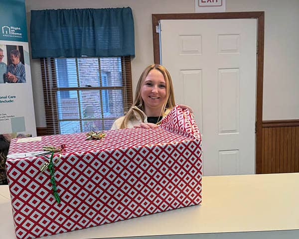 A large gift sits on a counter while Skylar starts to unwrap it.