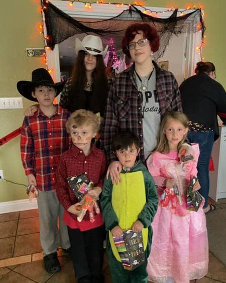 Several kids in costume trick-or-treating at the Princeton office.