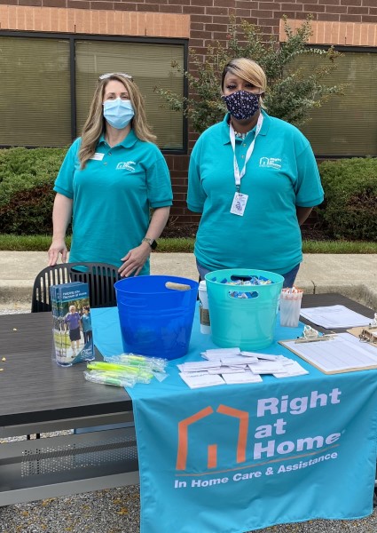 Kathleen and Ronda welcome job seekers to their booth at the outdoor job fair.