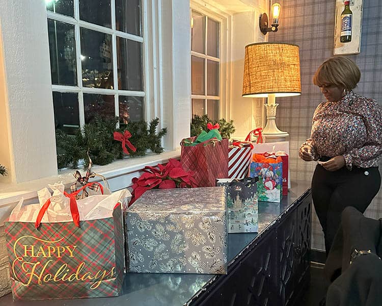 Ruby approaches a tables full of gifts.