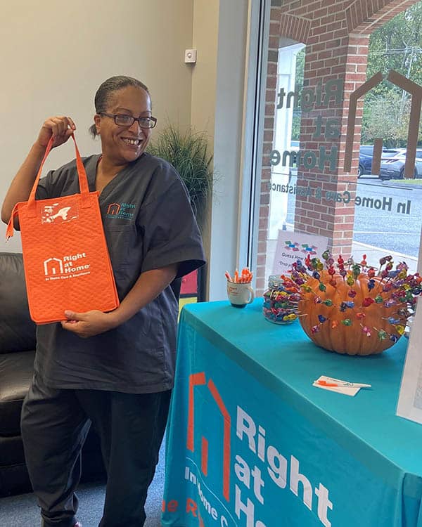 Lawanda holds the bag she won from the pumpkin pull game.