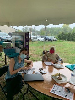 Two Right at Home Southern New Hampshire Caregivers undergoing annual training outside under a tent