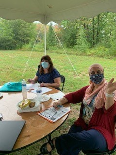 Two Right at Home Southern New Hampshire Caregivers undergoing annual training outside under a tent