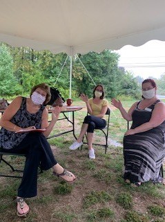 Three Right at Home Southern New Hampshire Caregivers undergoing annual training outside under a tent