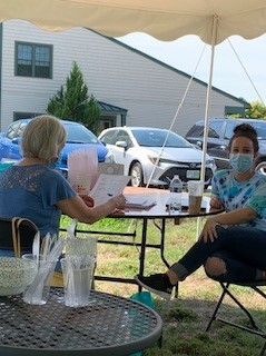 Two Right at Home Southern New Hampshire Caregivers undergoing annual training outside under a tent