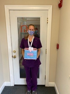 A Right at Home Southern New Hampshire Caregiver holding a treat bag