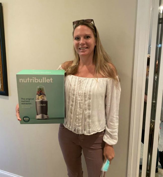 A Right at Home Southern New Hampshire caregiver holding a nutribullet prize she won