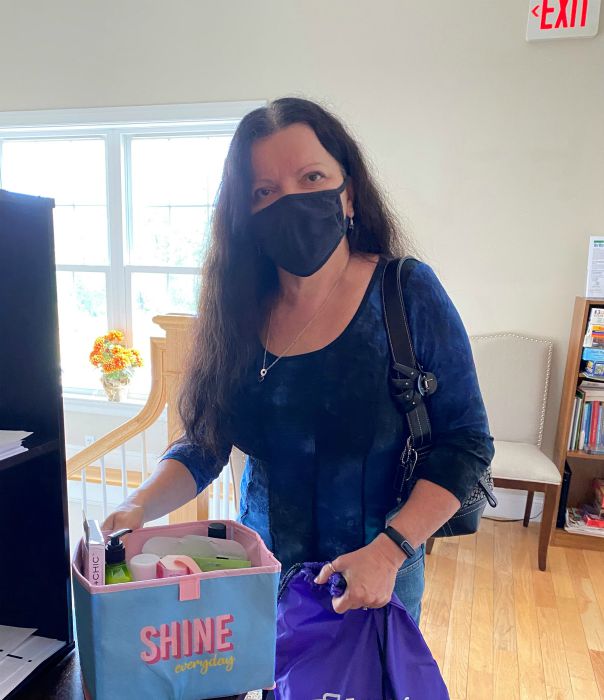 A Right at Home of Southern New Hampshire caregiver holding a self care basket prize she won