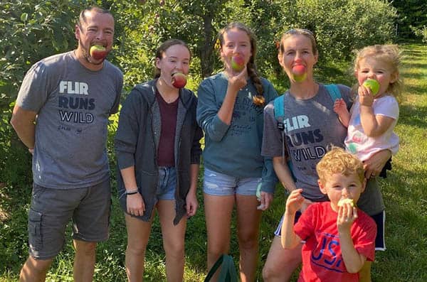 Kelly Dobe and her family with apples in their mouths