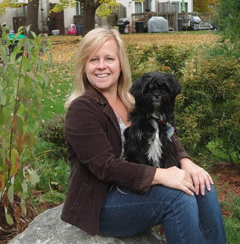 Sherrie Raymond, the Right at Home of Southern New Hampshire Heroes of the Pandemic Spotlight of the week, holding her dog.  