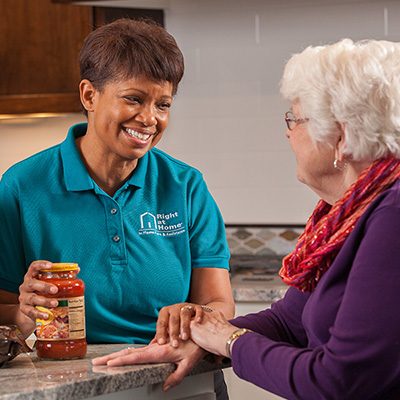 Female Caregiver with Client and Medications