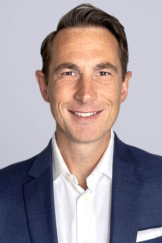 Standard Head-and-Shoulders Bio Photo of Matthew Malcolm Smiling at the Camera 