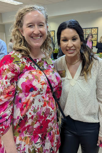 Two women pose side-by-side for a photo as part of the Acclaim Living event.