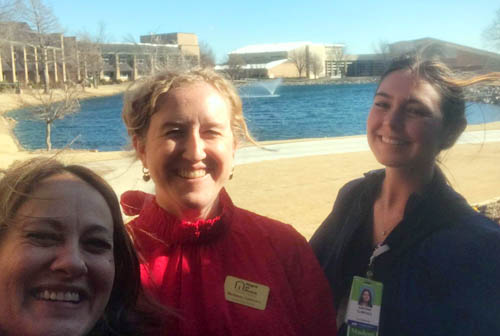 Three Female Staff Members Posting Side-by-Side Outdoors at a Job Fair