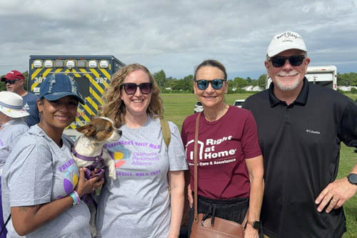 Three women and one man pose side by side smiling at the camera from the Oklahoma City Parkinson's Walk Fundraiser